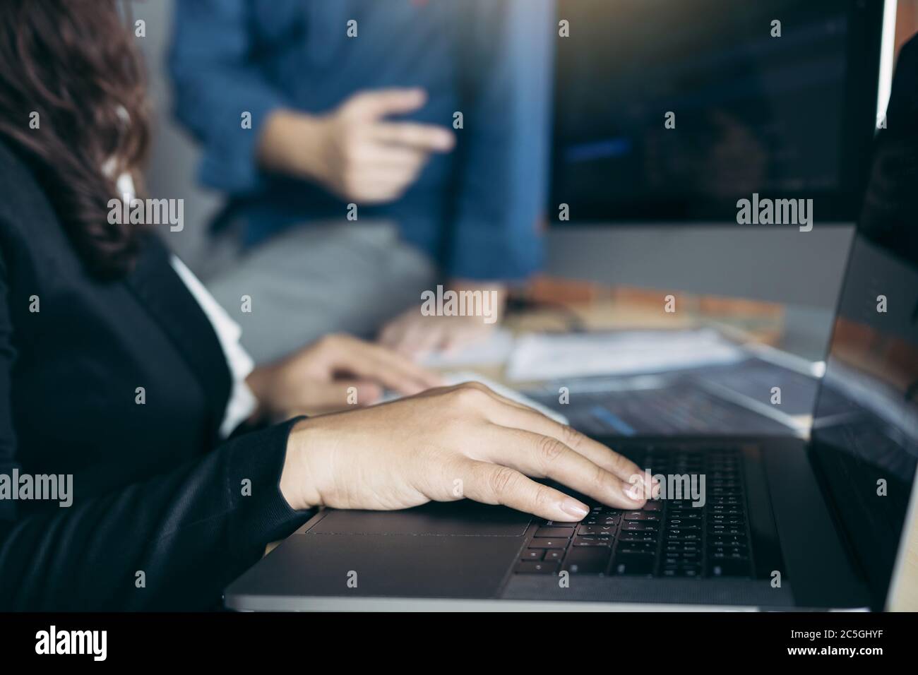 Two software developers are analyzing together about the code written into the program on the computer. Stock Photo