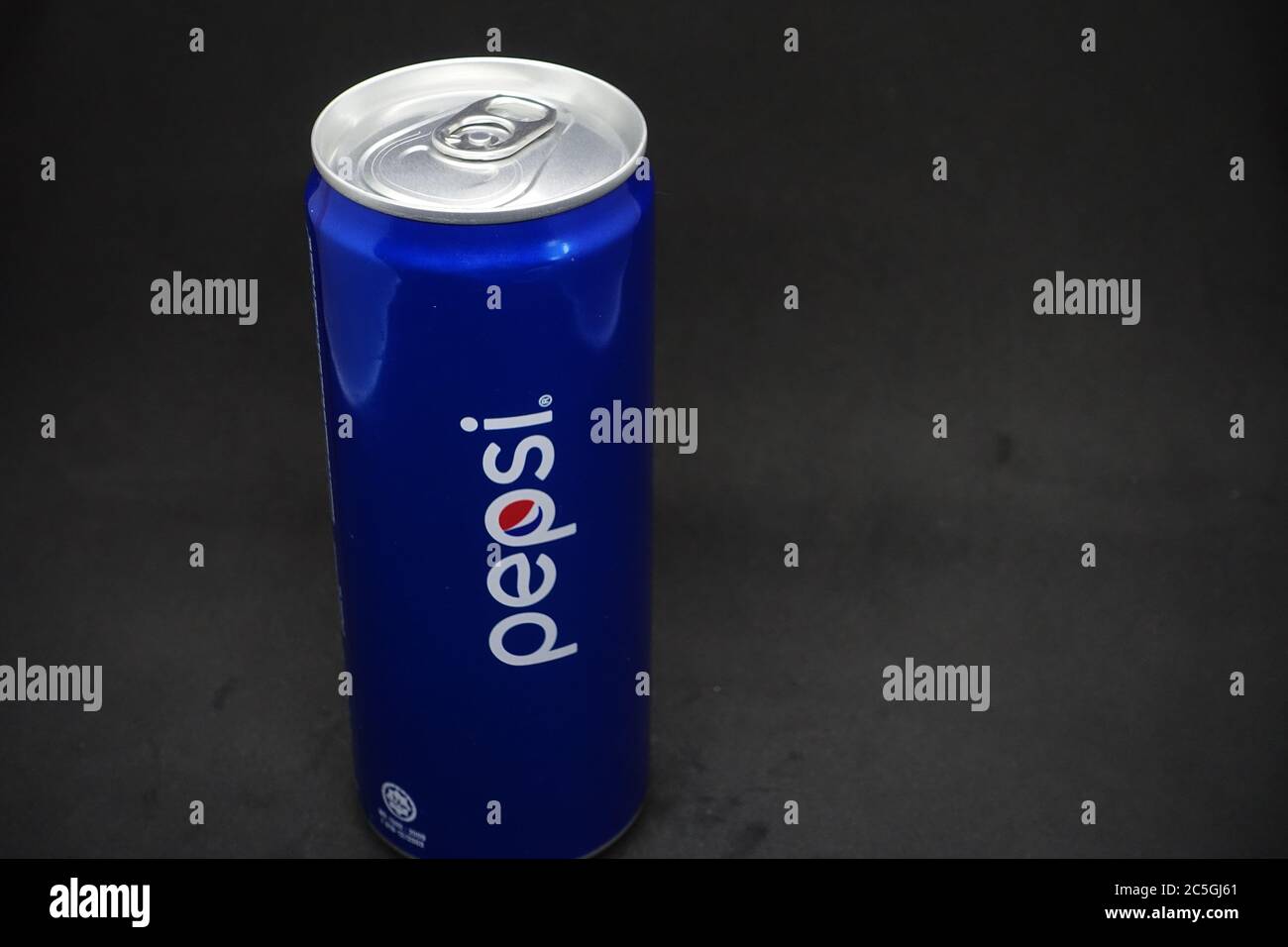 A can of blue pepsi against isolated black background Stock Photo - Alamy