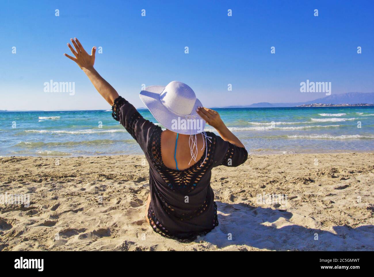 Young woman in white hat on the beach Stock Photo - Alamy