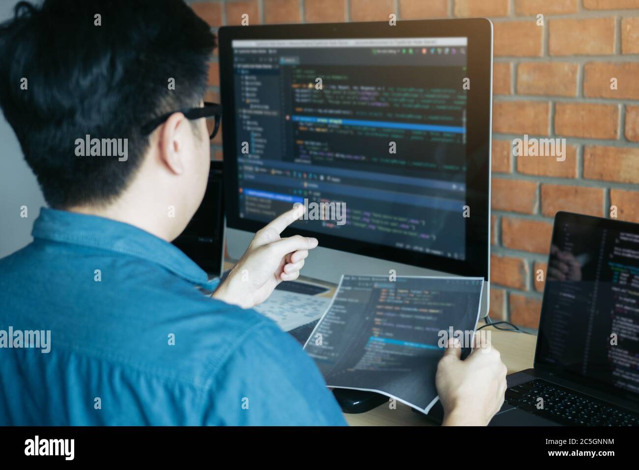 Developing programming and coding technologies working in a software engineers developing applications together in office. Stock Photo