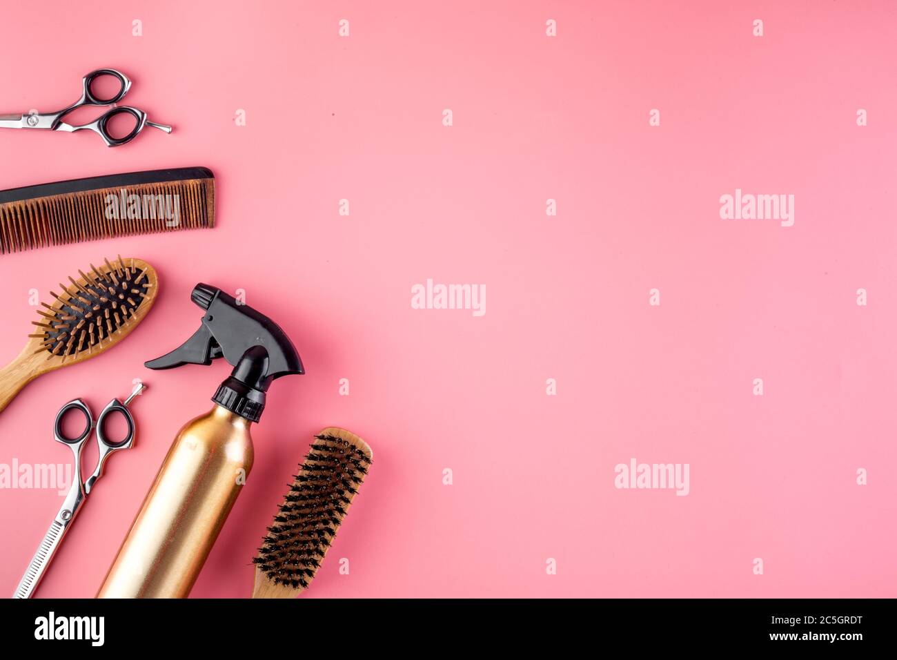 Hairdresser set in beauty salon. Combs, scissors, spray on pink desk
