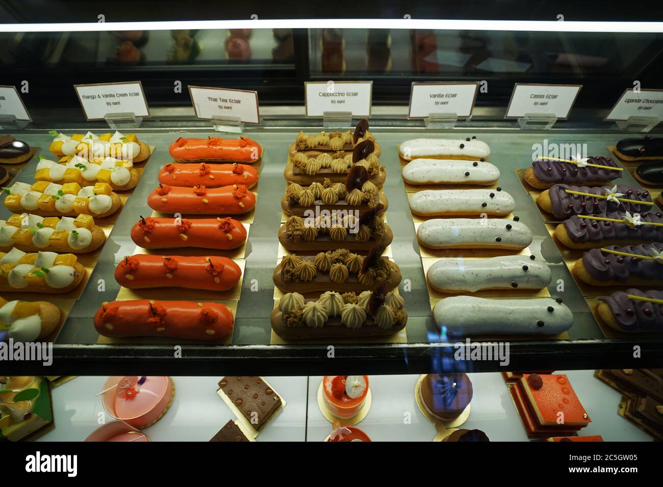 Assorted flavor colorful eclair and French pastry bakery displayed in glass  showcase box Stock Photo - Alamy