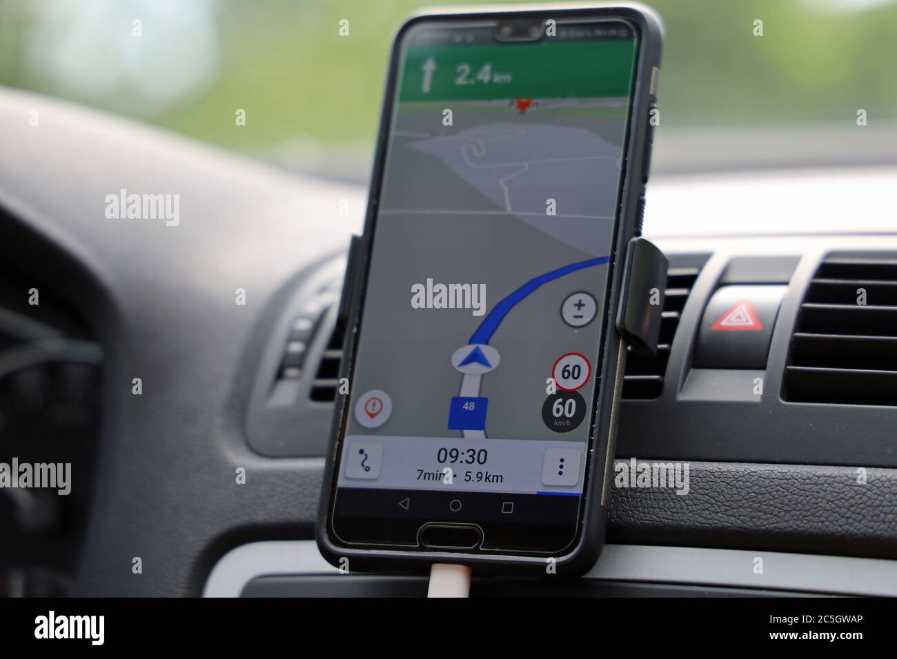 smartphone with navigator map on dashboard in a car, close up of navigation with an gps app Stock Photo