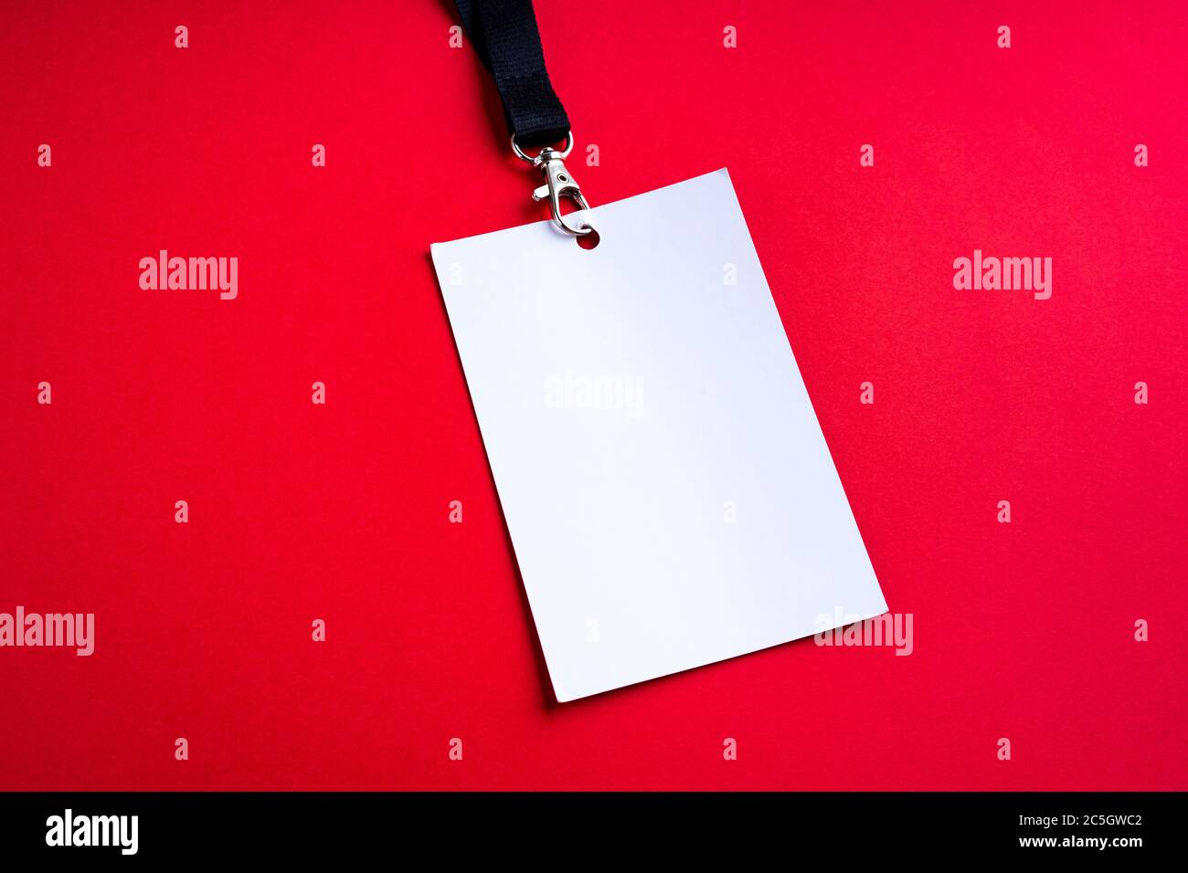 Blank white paper bagde on red background, lanyard mockup Stock Photo