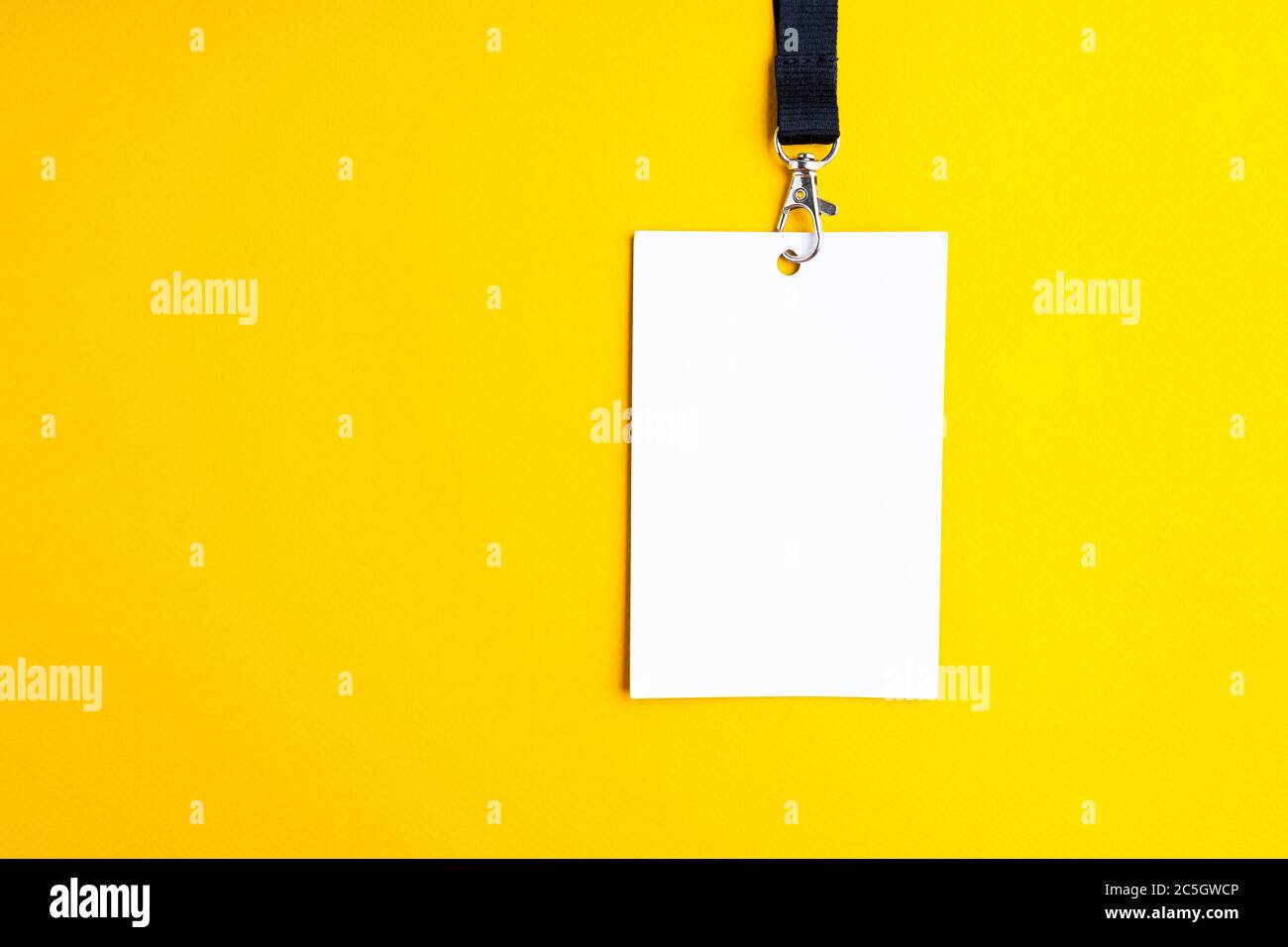 Blank white paper bagde on yellow background, lanyard mockup Stock Photo -  Alamy
