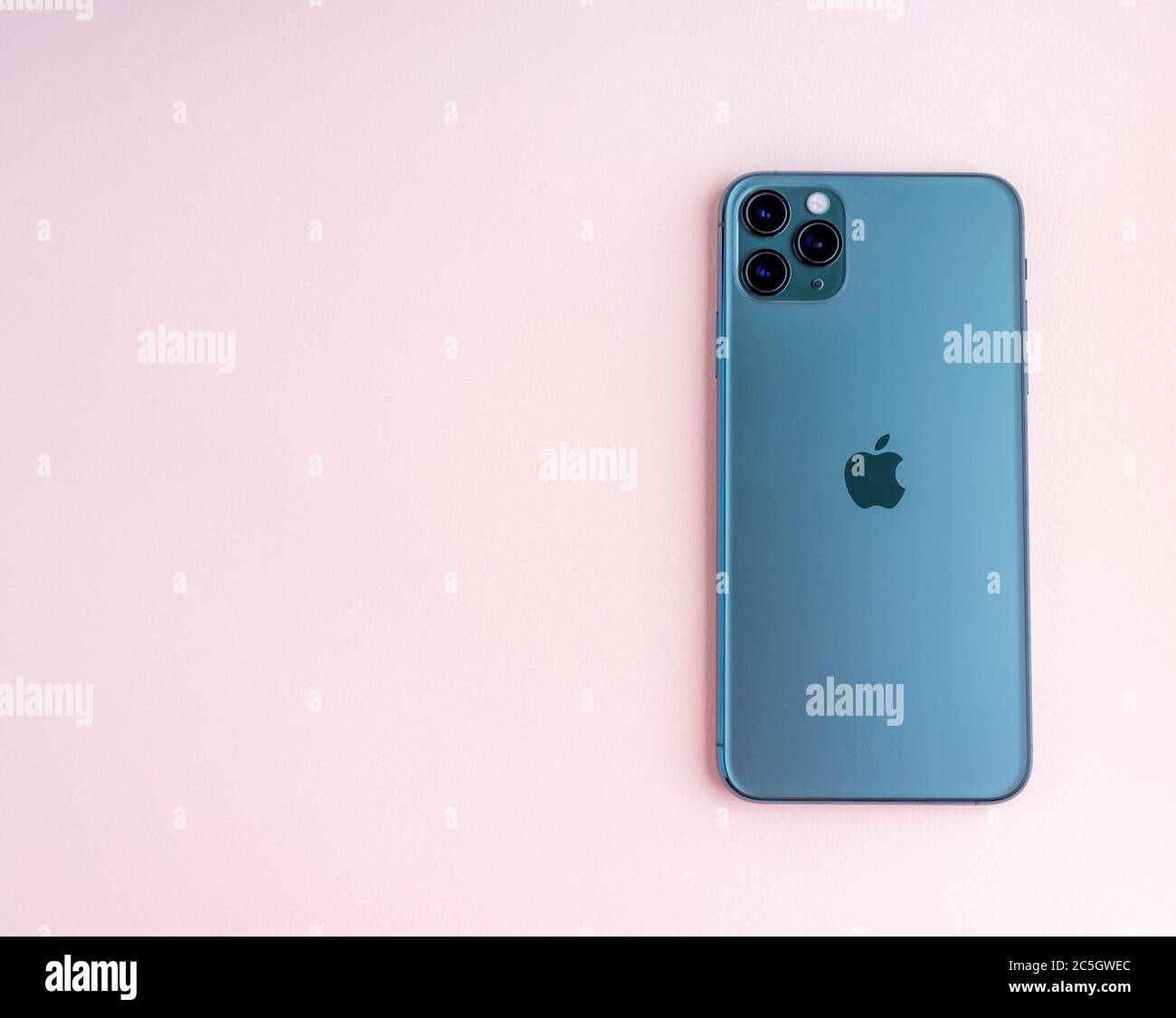 Sankt-Petersburg, Russia - November 3, 2019: Iphone 11 Max Pro (midnight green) over pink background studio shot Stock Photo
