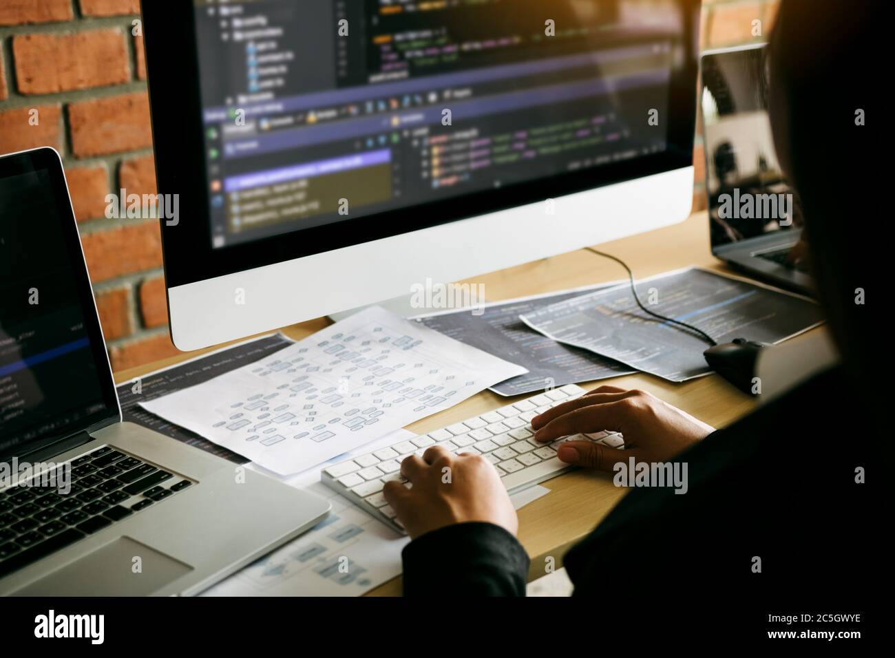 Two partnerships developing programming and coding technologies working on laptop and analyzing together. Stock Photo