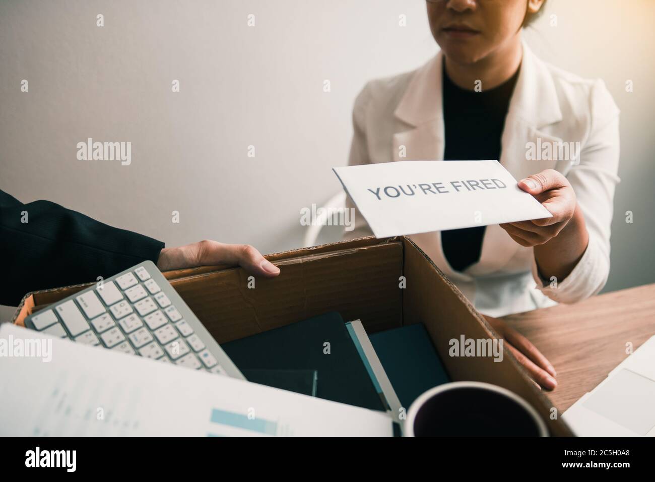 Female Manager Submits A Resignation Letter Or Envelope To The Male Employee At The Office Stock Photo Alamy