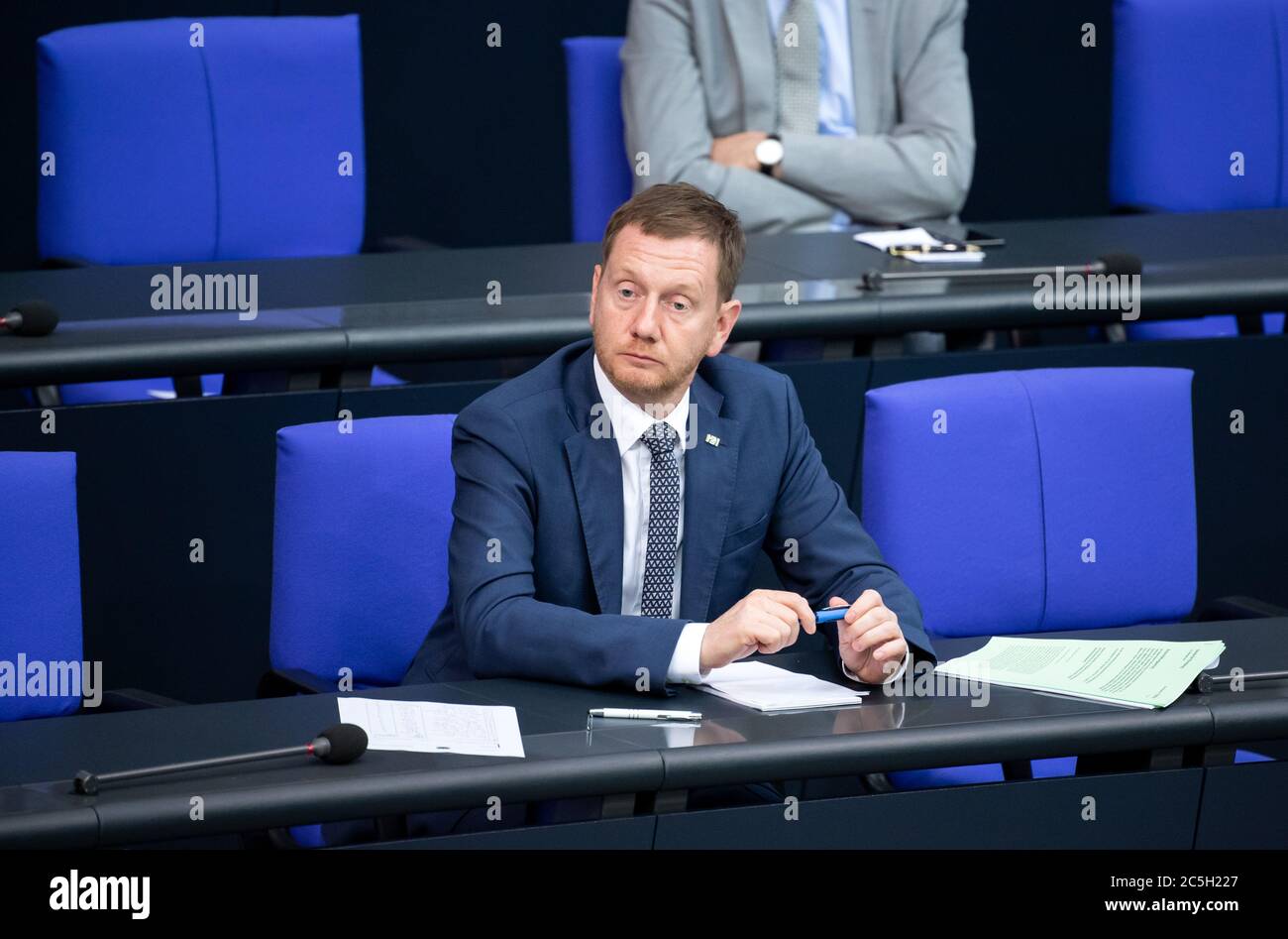 Berlin, Germany. 03rd July, 2020. Michael Kretschmer (CDU), Prime Minister of Saxony, follows the plenary session in the German Bundestag. The main topics of the 171st session of the 19th legislative period are the adoption of the Coal Exit Act, a topical hour on the excesses of violence in Stuttgart, as well as debates on electoral law reform, the protection of electronic patient data, the welfare of farm animals and the German chairmanship of the UN Security Council. Credit: Bernd von Jutrczenka/dpa/Alamy Live News Stock Photo