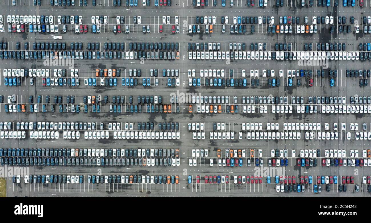 Rows of new cars in the parking lot. Aerial view of large parking lot full of cars of various colors Stock Photo