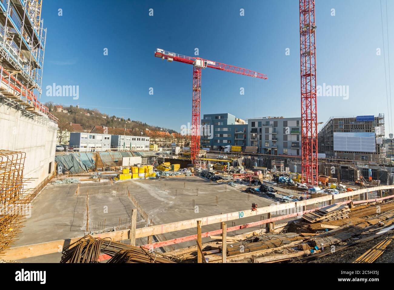 Large construction site with finished foundation, cranes and building material Stock Photo