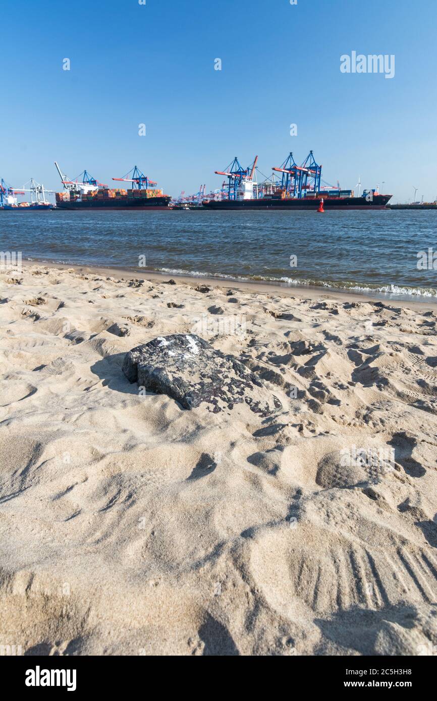 Beach at the Elbe river in Hamburg with container terminal and ships in ...