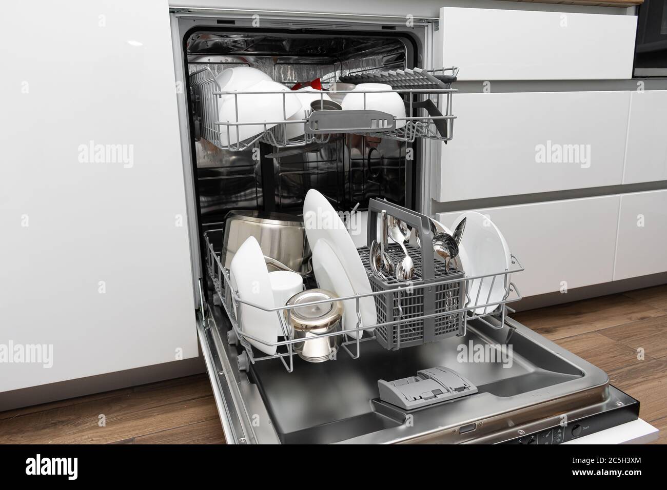 Loading a dishwasher. Dishwasher with clean dishes Stock Photo Alamy