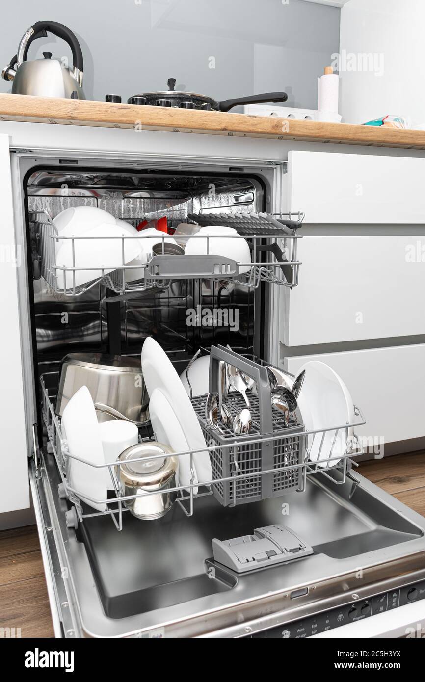 Loading a dishwasher. Dishwasher with clean dishes Stock Photo Alamy