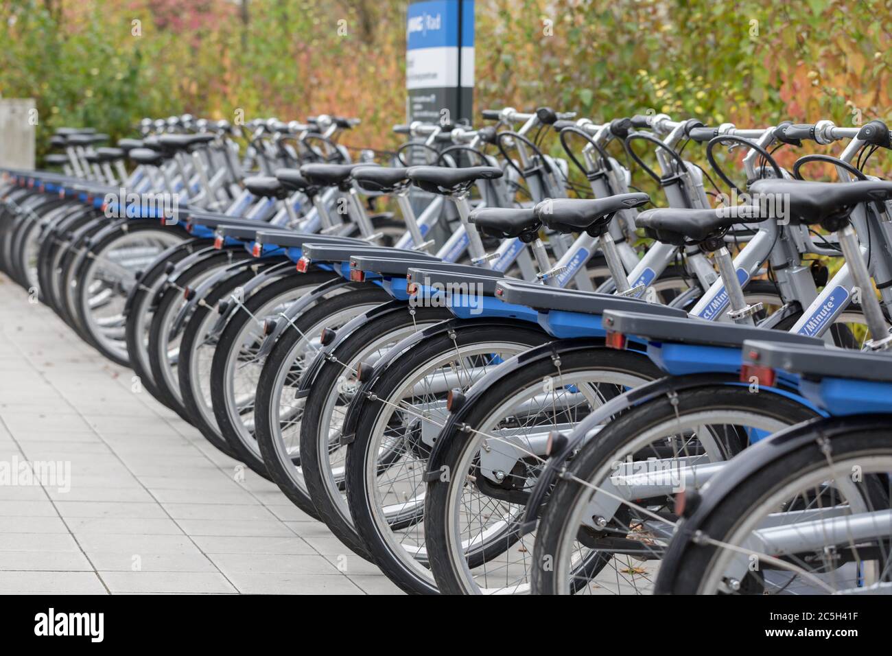 Bicycles parked in front of a metro station in Munich. Operated by MVG (Munich Public Transport).  Lined up, in a row. Stock Photo