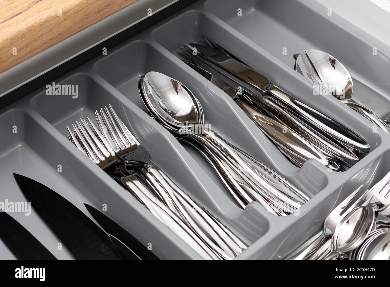 Stainless steel cutlery set in drawer. Opened kitchen drawer Stock ...