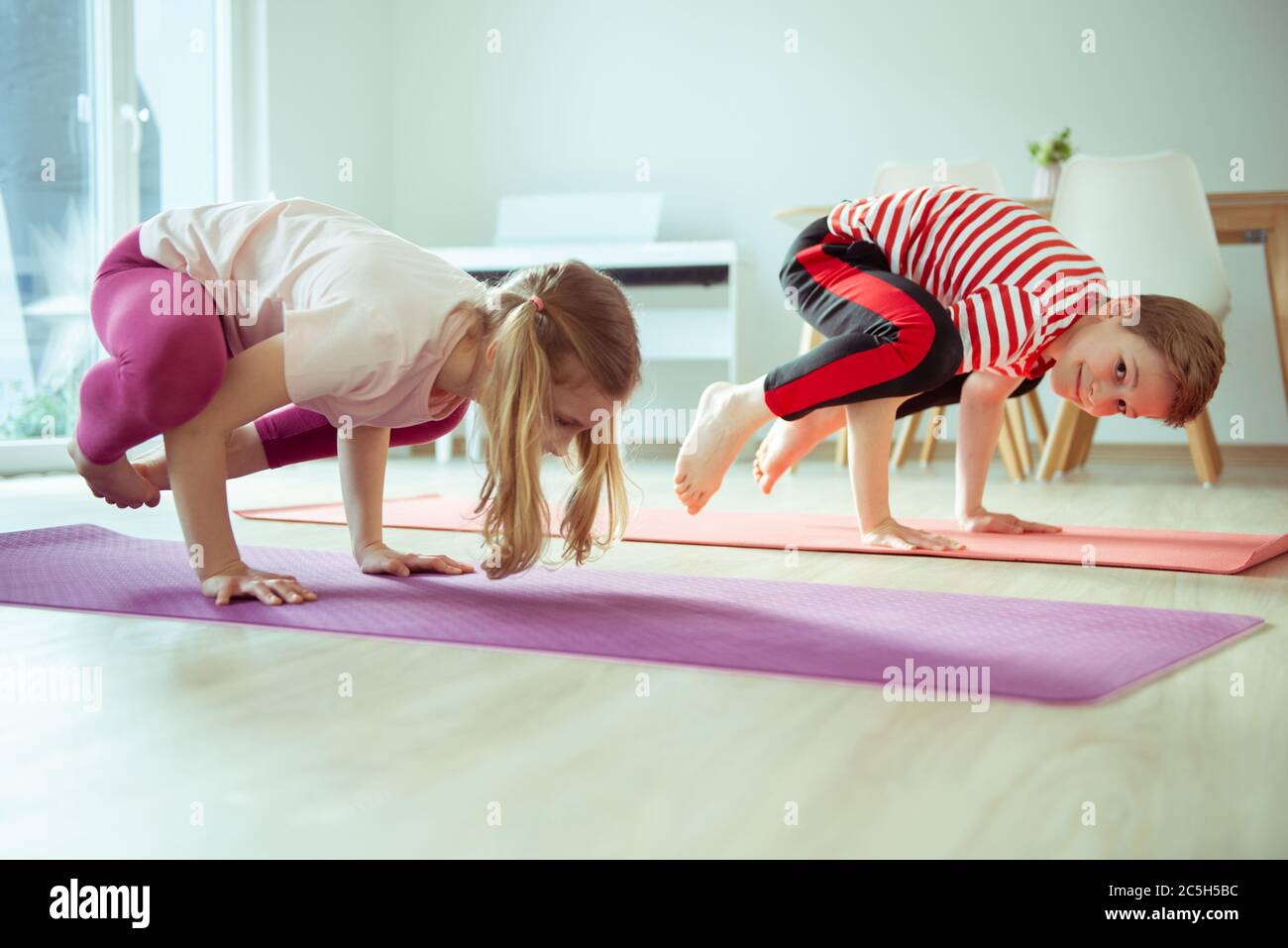 Happy siblings children making yoga at home dueing coronavirus ...