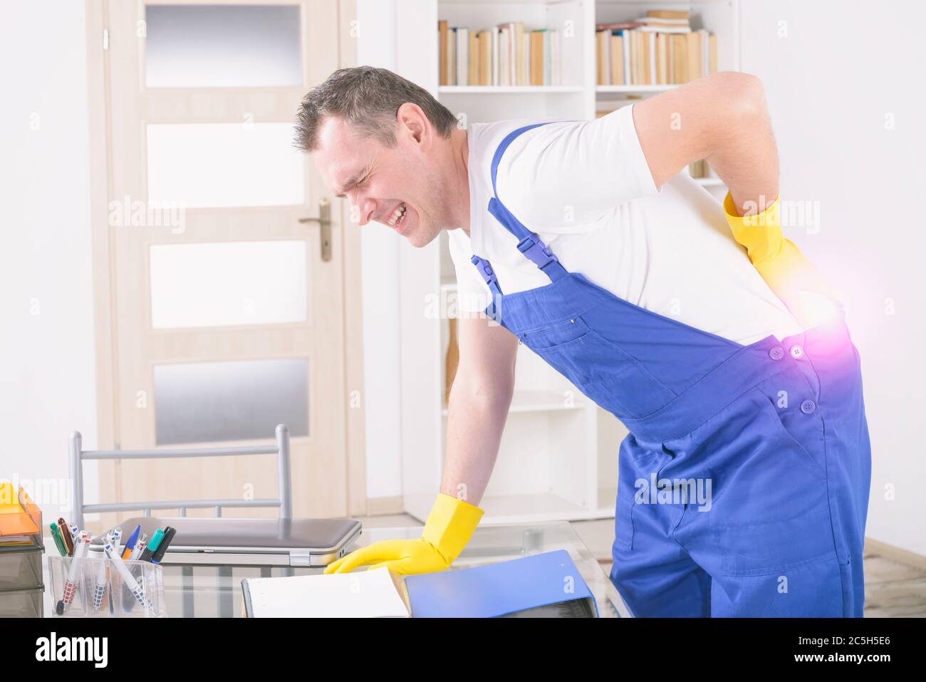 Man worker with back injury, concept of accident at work Stock Photo