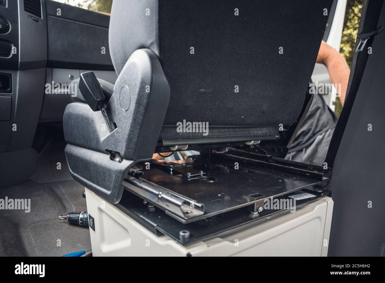 Swivel seat installation inside a van Stock Photo