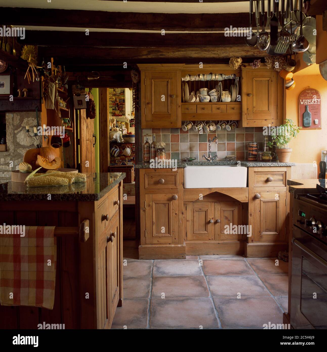 Small Cottage Kitchen With Wooden Units And Tiled Floor Stock Photo Alamy