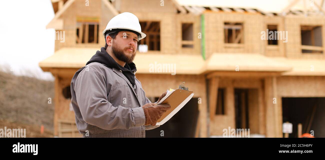 Banner of engineer drawing plan in notebook at construction site. Stock Photo