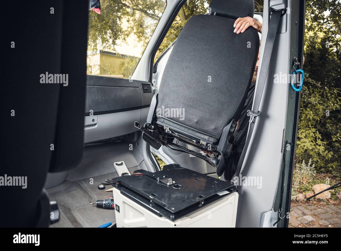 Swivel seat getting installed in a camper van Stock Photo