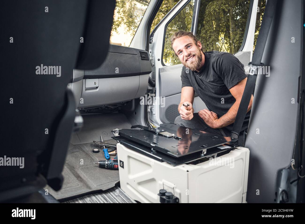 Happy man working inside his camper van Stock Photo