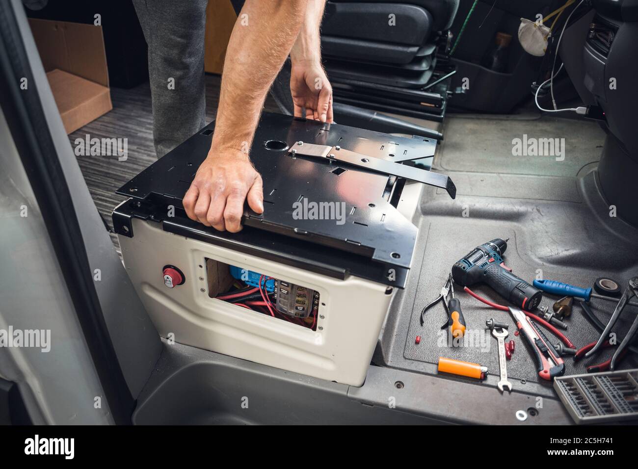swivel seat base installation in a camper van stock photo