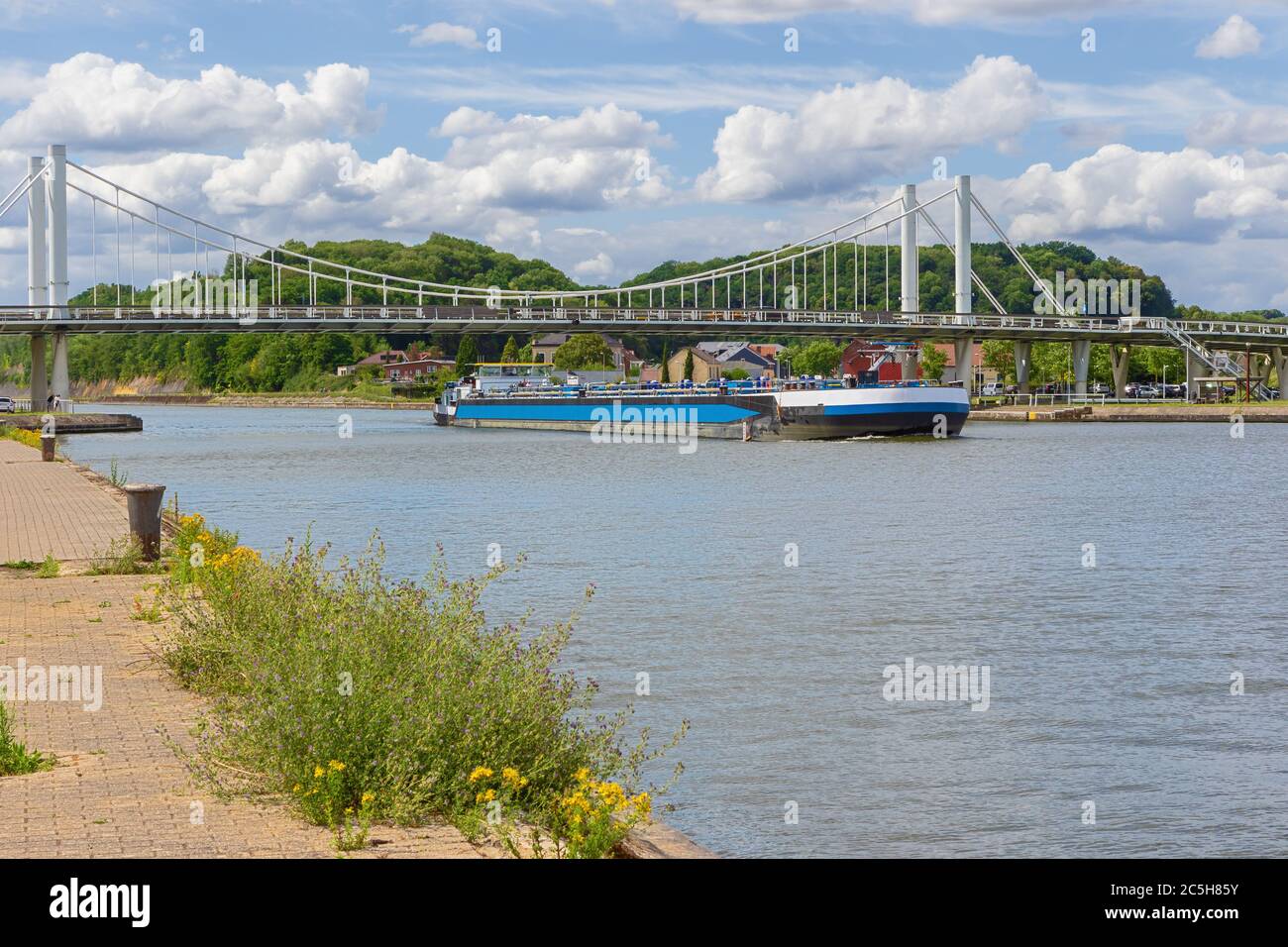 Barge passing under the bridge of Kanne on the Albert Canal Stock Photo