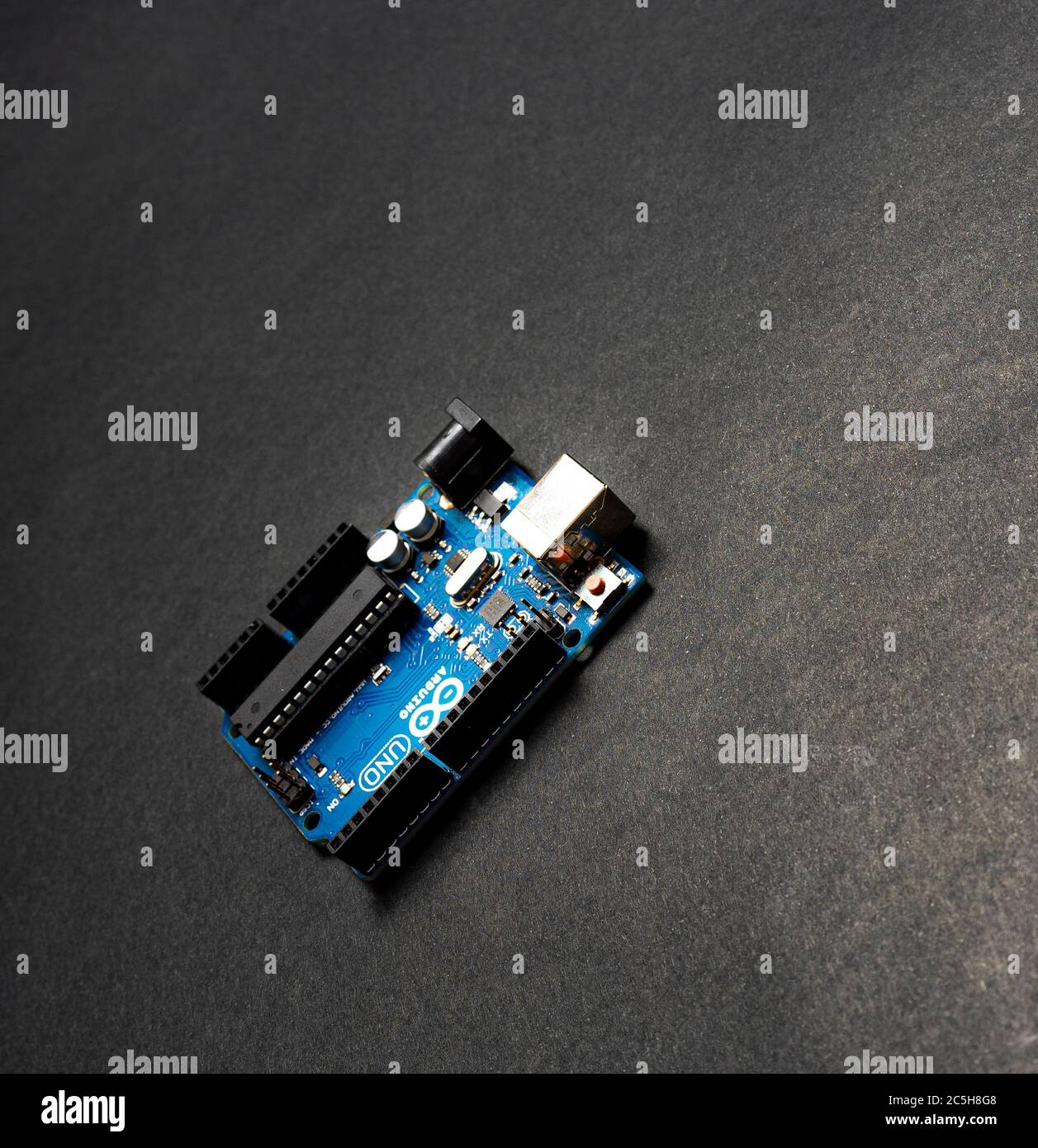Sankt-Petersburg, Russia - February 28, 2020: Arduino UNO board on black background, close up. Microcontroller for programming. Stock Photo