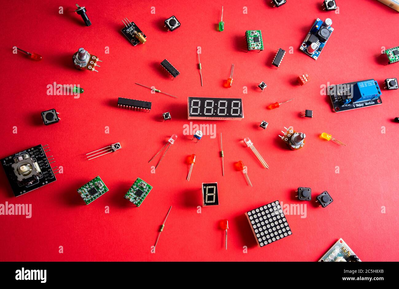 Micro electronics arduino DIY components over red background, top view ...