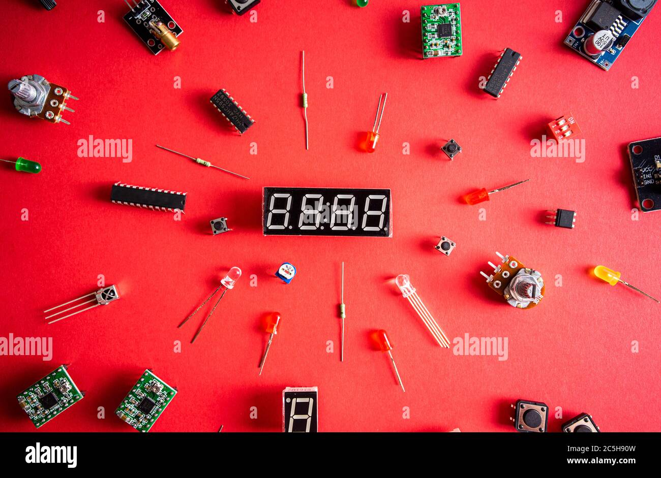 Micro electronics arduino DIY components over red background, top view ...