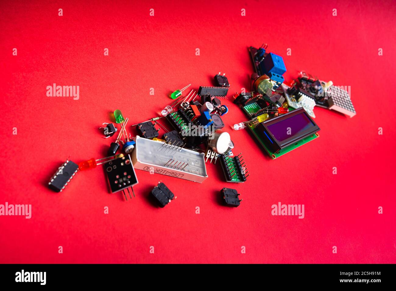 Micro electronics arduino DIY components over red background, top view ...