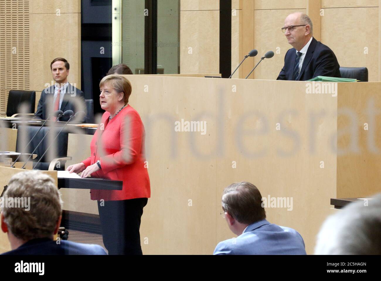 Berlin, Germany. 03rd July, 2020. Chancellor Angela Merkel gives a speech in the Bundesrat on the objectives of the EU Council Presidency, Dietmar Woidke (SPD, r), President of the Bundesrat, follows the speech. (Photographed through a window) Credit: Wolfgang Kumm/dpa/Alamy Live News Stock Photo