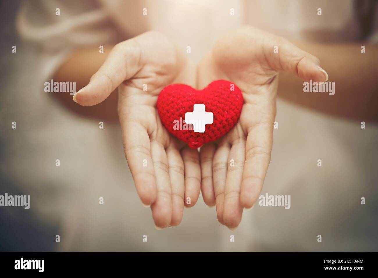 Hand giving red heart for help blood donation healthcare together share love to fight disease concept. Stock Photo