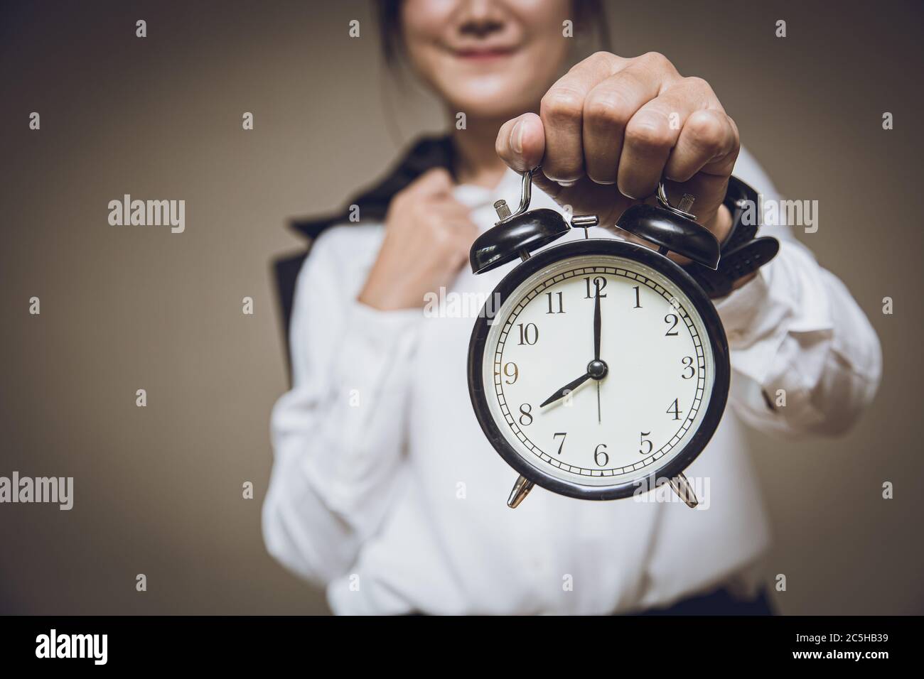 Business time clock or working hourse morning times remind alert warning concept, People holding retro bell alarm clock. Stock Photo