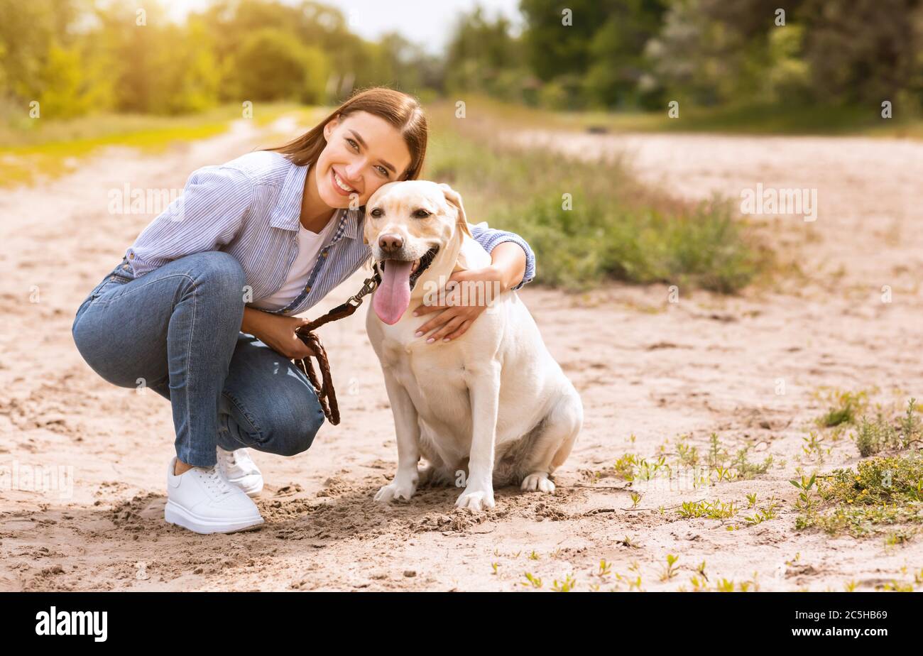 Excited woman and golden retriever walking outdoors Stock Photo - Alamy