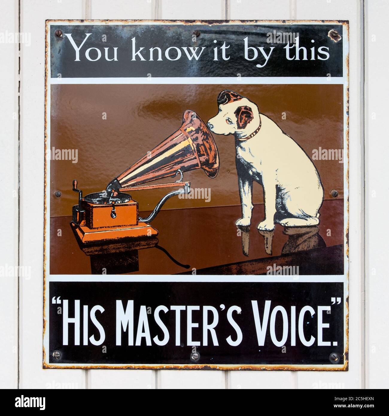 NR SOUTHAMPTON,UK - 25 June 2013: Old style tin advertising board for His Master's Voice displayed on painted wood background. On 25 June 2013 Near So Stock Photo