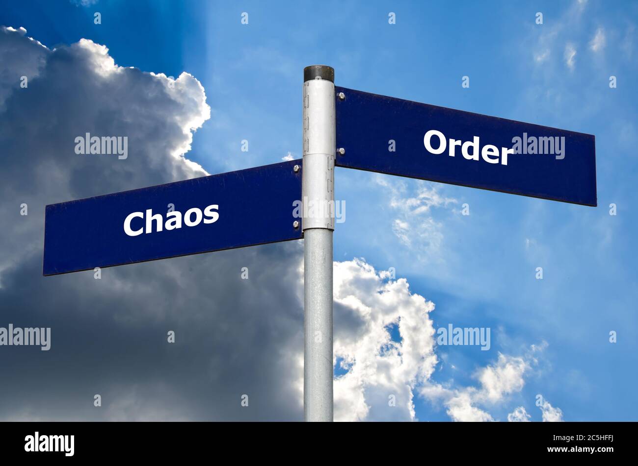 Street sign in front of dark clouds symbolizing contrast between 'chaos' and 'order' Stock Photo
