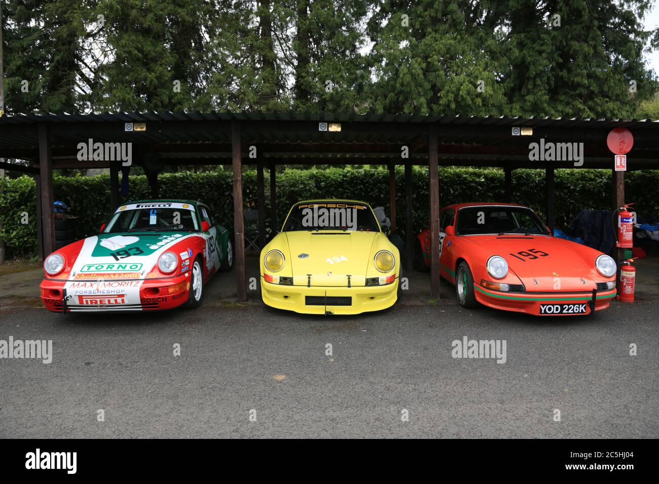 Three Porsche 911's parked in the paddock at Shelsley Walsh speed hill climb, Worcestershire, England, UK. Stock Photo