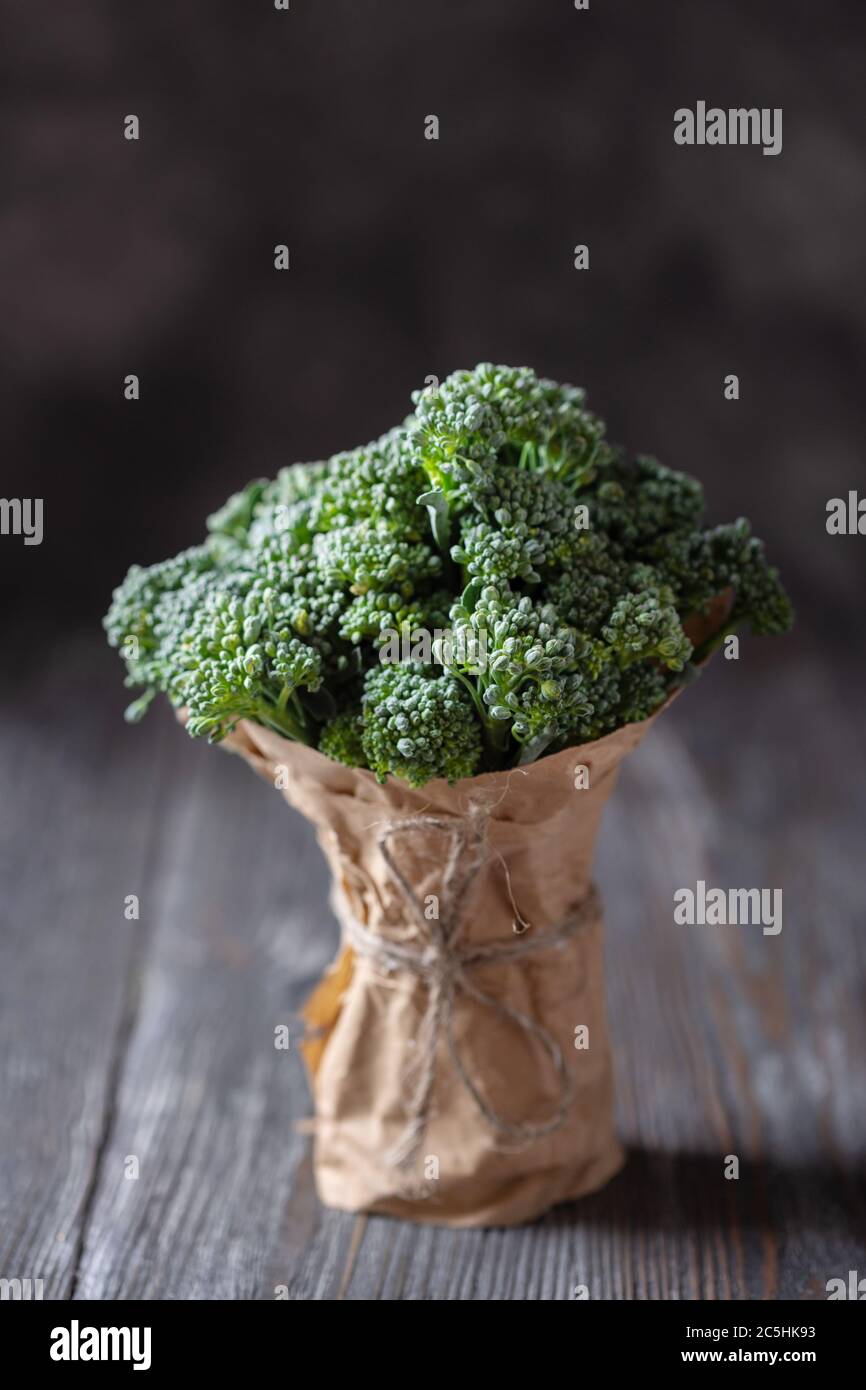 Bunch of broccolini on wooden table. Angle view. Stock Photo