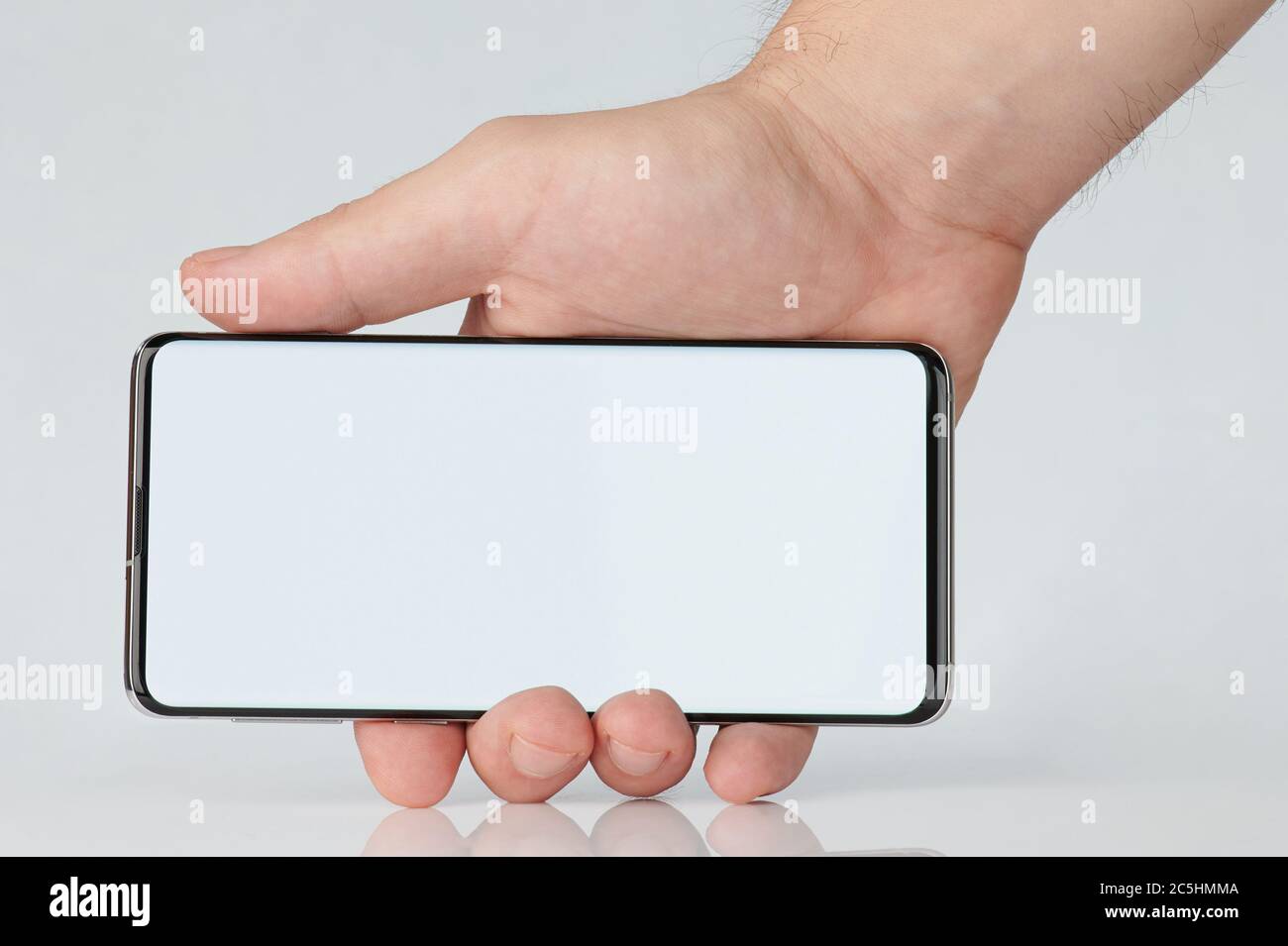 Smartphone with clean display in hand on horizontal orientation isolated Stock Photo