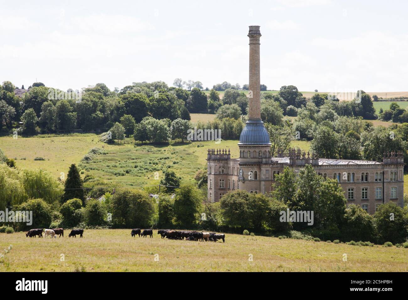Views of Bliss Mill in Chipping Norton with cattle grazing on the hills in West Oxfordshire in the UK Stock Photo