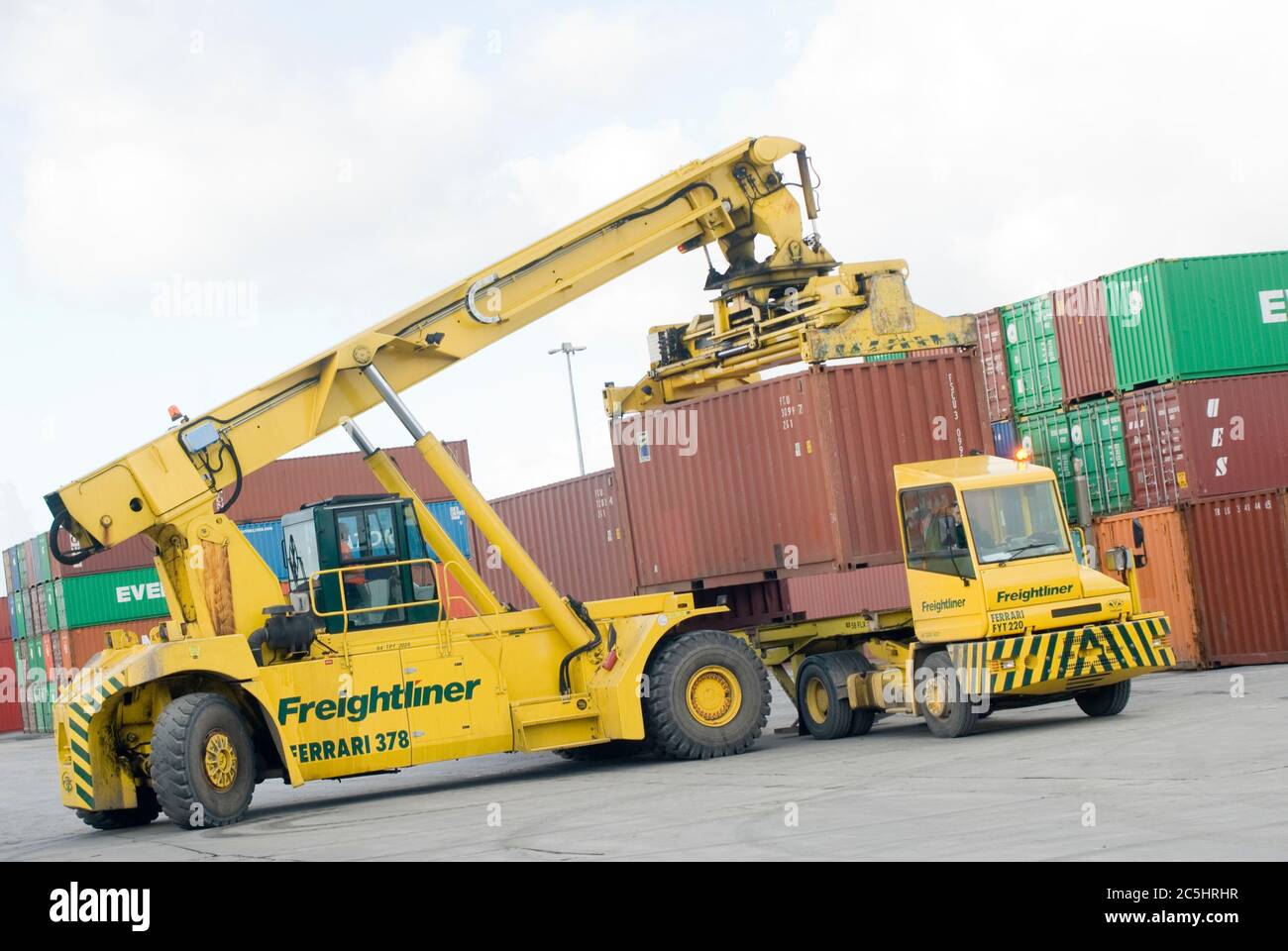 CVS Ferrari reach stacker and terminal tractor being used to move shipping containers at Manchester Euroterminal, Trafford Park, Manchester, England. Stock Photo