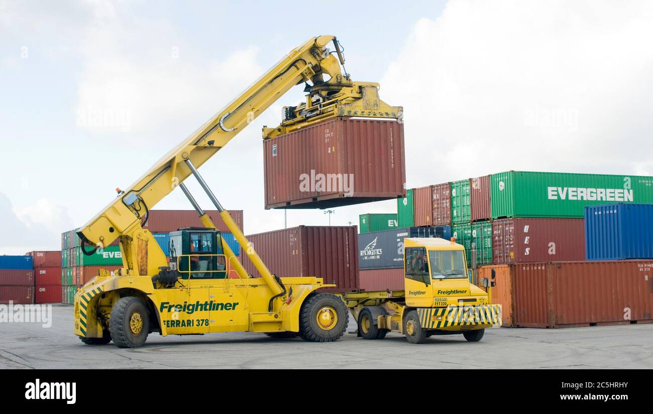 CVS Ferrari reach stacker and terminal tractor being used to move shipping containers at Manchester Euroterminal, Trafford Park, Manchester, England. Stock Photo