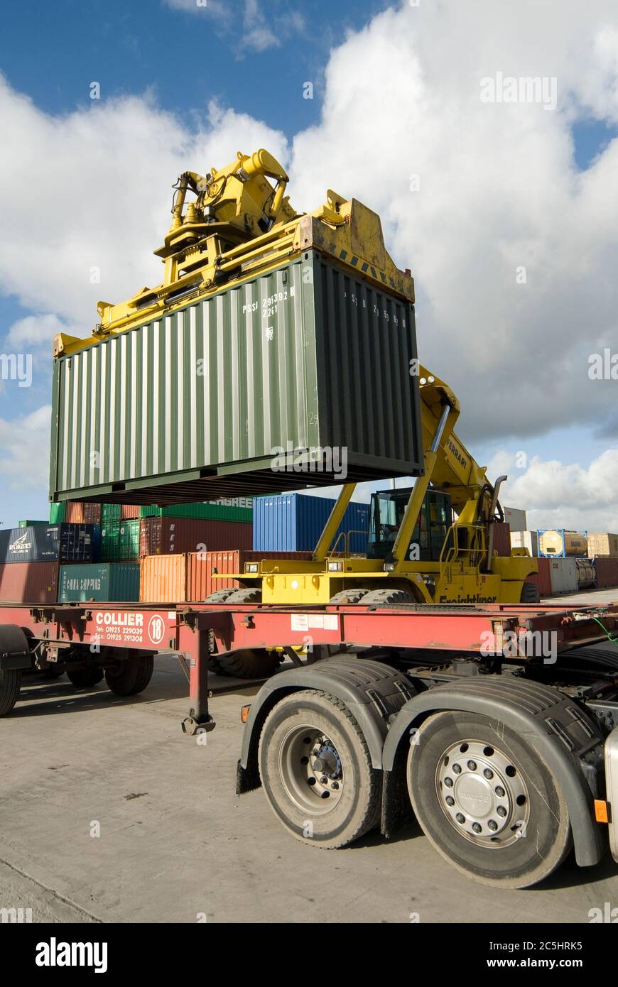 CVS Ferrari reach stacker being used to load a shipping container onto a lorry at Manchester Euroterminal, Trafford Park, Manchester, England. Stock Photo
