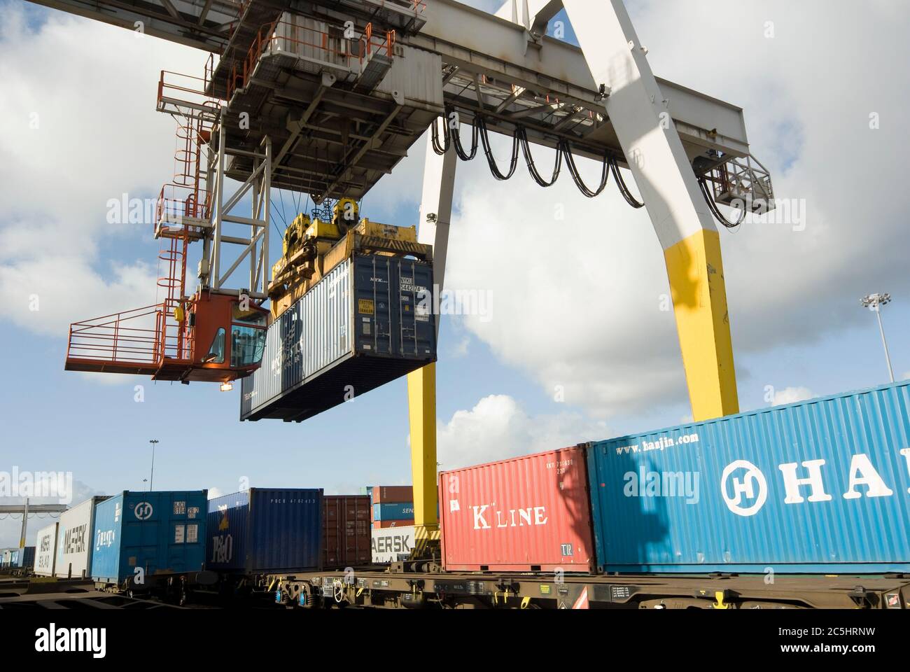 Rail mounted crane being used to load and unload shipping containersat ...