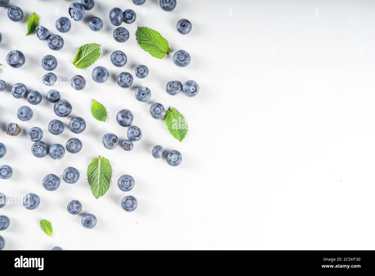 Flatlay pattern with fresh ripe blueberries on white background Stock Photo