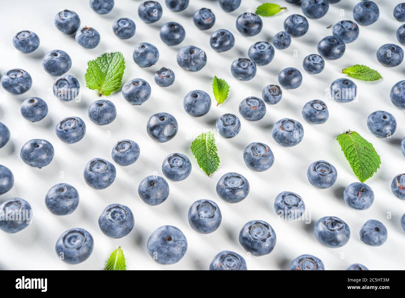 Flatlay pattern with fresh ripe blueberries on white background Stock Photo
