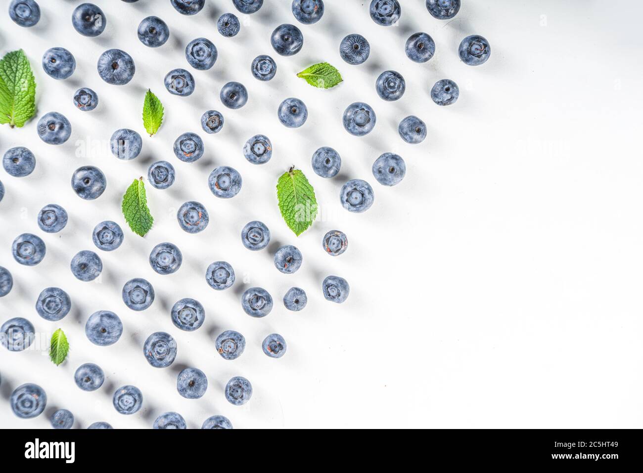 Flatlay pattern with fresh ripe blueberries on white background Stock Photo